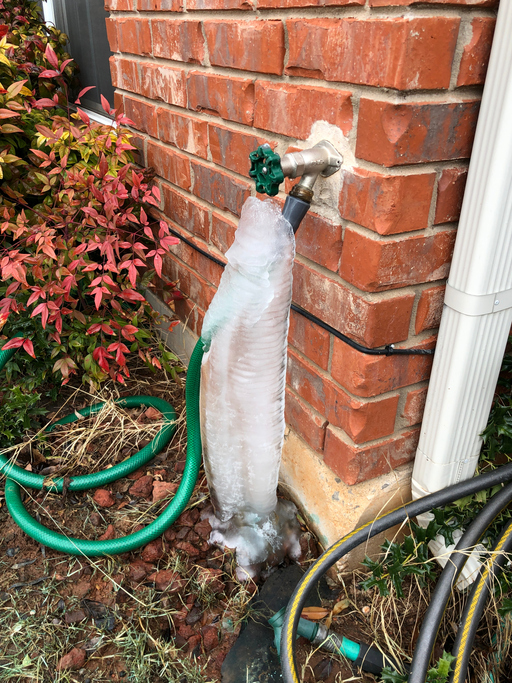 Water from a faucet frozen in winter